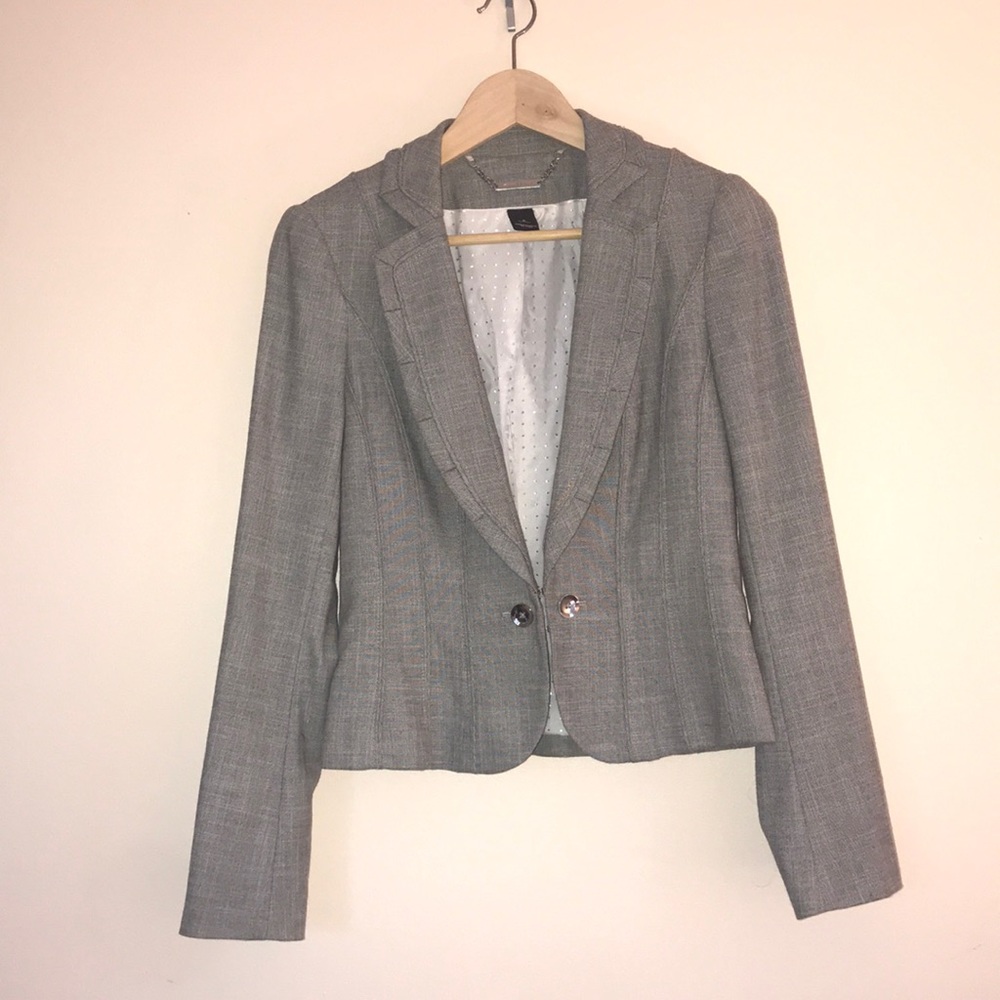 Gray blazer with piping detail.